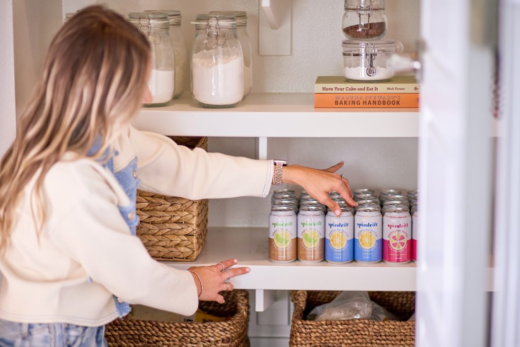 home organizer placing pantry organization